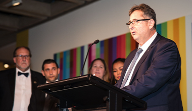 Paul Tsimopoulos speaking at an award event
